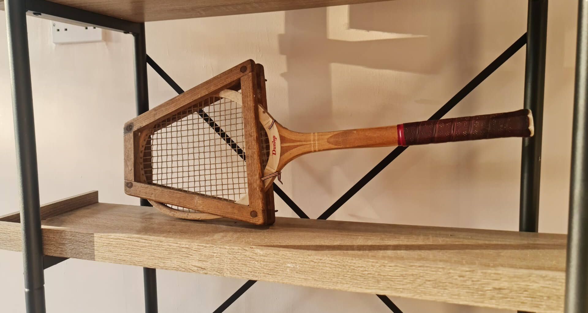 Tennis racket on shelf inside bespoke gym